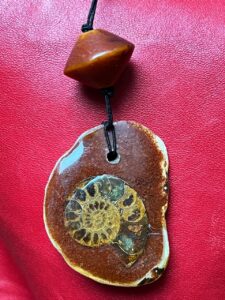 Création personnelle, perle d'ambre phénolic années 30, Ammonite, coquillage, sable rouge du désert marocain. Création personnelle, perle d'ambre phénolic années 30, Ammonite, coquillage, sable rouge du désert marocain.